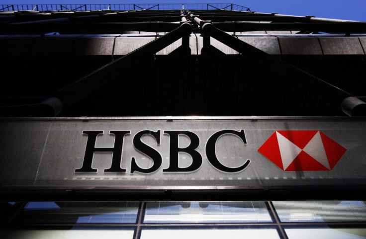 An HSBC bank logo is highlighted by the sun in London