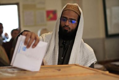 An Egyptian man casts his vote at a polling station during Parliamentary elections in Cairo