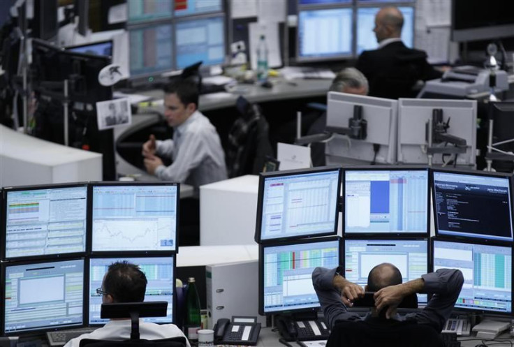 Traders work at their desks at the Frankfurt stock exchange