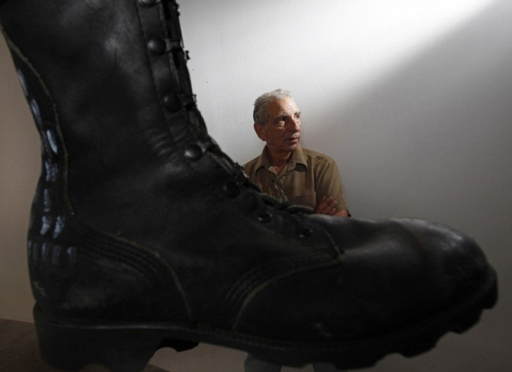 Joe Fornelli, artist liason for the National Veterans Art Museum, is seen beside Jon Turner&#039;s Prayer Boots in Chicago