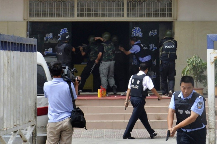 A handout picture shows armed policemen trying to rescue hostages at a police station during a clash in Hotan
