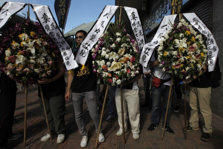 Wreaths are displayed in Hong Kong during a ceremony to remember the victims of the Wenzhou&#039;s train accident