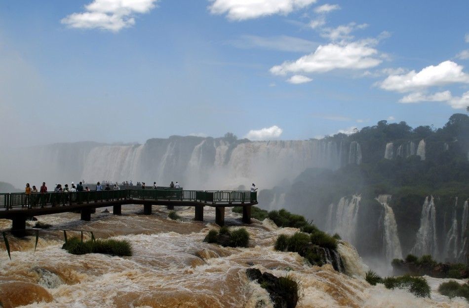 Tourists watch the Iguazu Falls from a viewing point on the border of Argentina039s province of Misiones and Brazil039s State of Parana