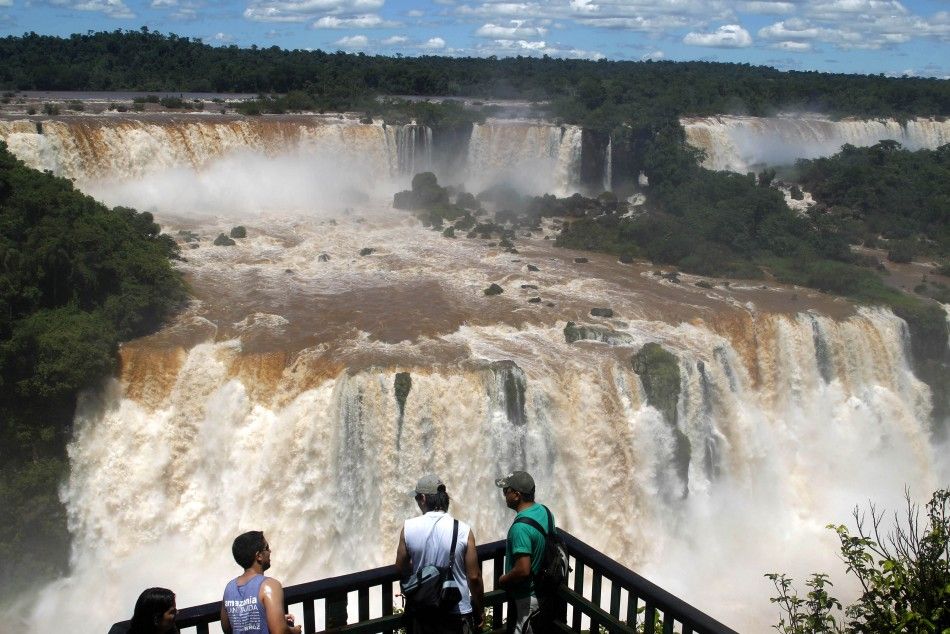 Tourists watch the Iguazu Falls from a viewing point on the border of Argentina039s province of Misiones and Brazil039s State of Parana.
