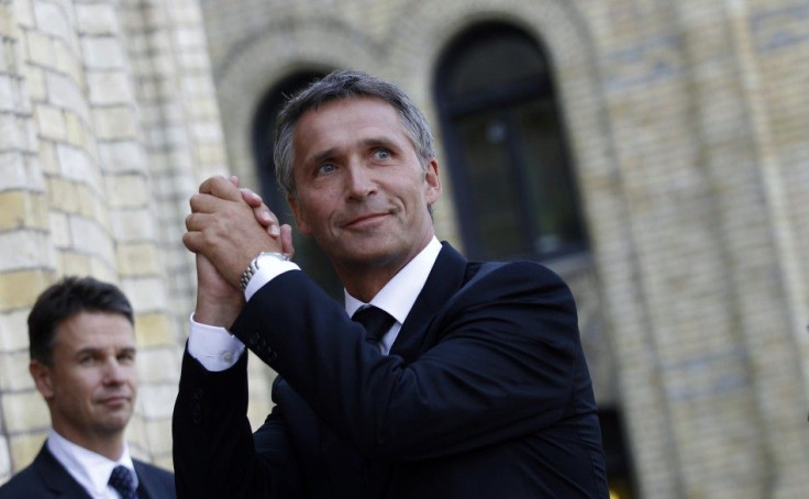 Norway&#039;s Prime Minister Stoltenberg gestures to supporters outside the Storting in Oslo
