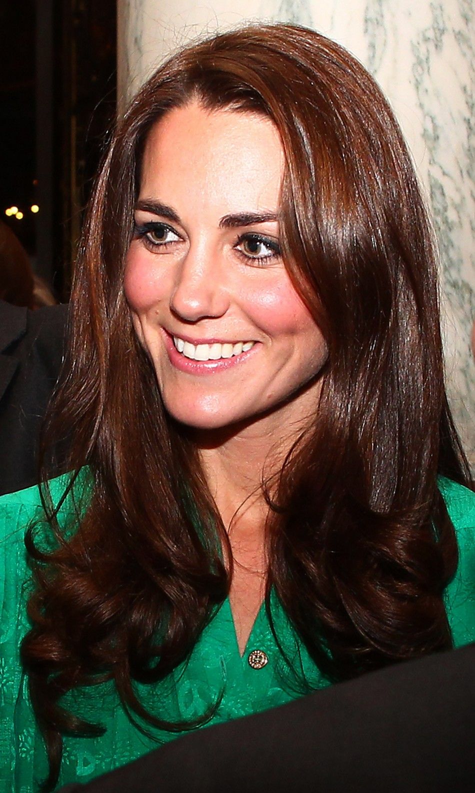 Catherine, Duchess of Cambridge speaks with guests during a reception for members of the media at Buckingham Palace in London November 28, 2011.