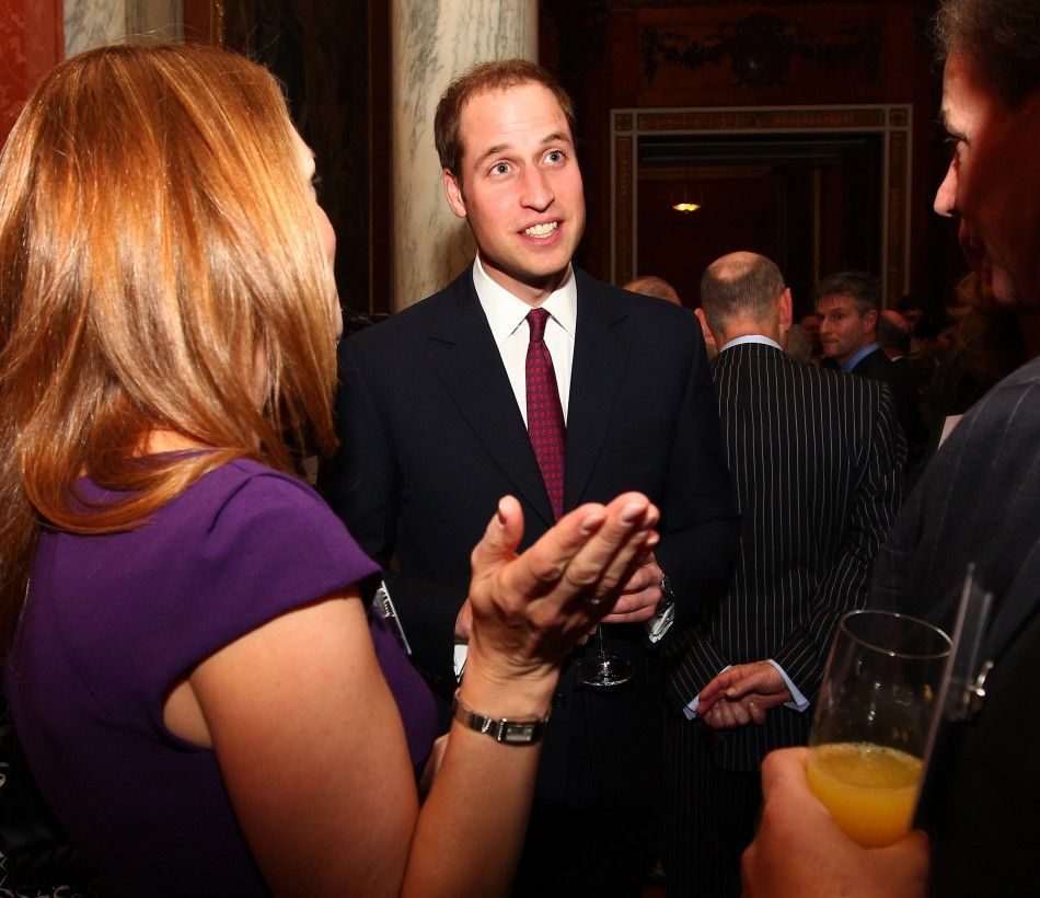 Britains Prince William speaks with guests during a reception for members of the media at Buckingham Palace in London November 28, 2011. 