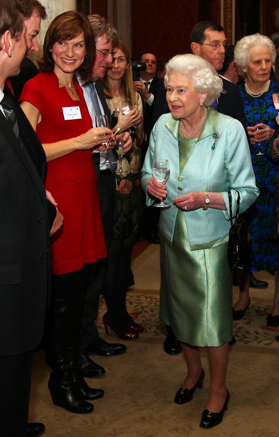 Britains Queen Elizabeth meets BBC television presenter Fiona Bruce L during a reception for members of the media at Buckingham Palace in London November 28, 2011. 
