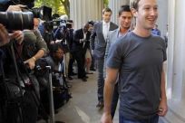 Facebook founder and CEO Mark Zuckerberg walks away after briefly speaking to reporters during a visit to the Massachusetts Institute of Technology in Cambridge, Massachusetts November 7, 2011.
