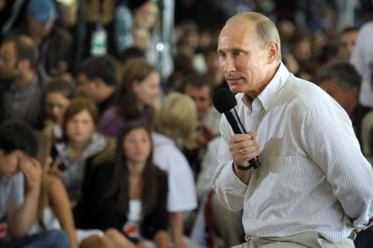 Russian Prime Minister Putin answers questions from the audience during his visit to the summer camp of the pro-Kremlin youth group &quot;Nashi&quot; at lake Seliger