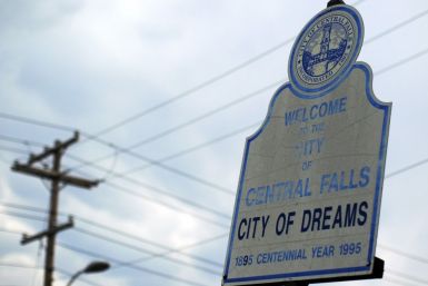 A sign calling Central Falls, Rhode Island a &quot;City of Dreams&quot; marks the town&#039;s boundary on Higginson Avenue