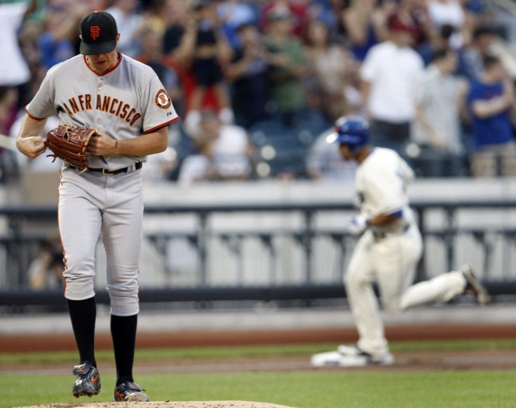 San Francisco Giants pitcher Barry Zito looks down after giving up a solo home run to the New York Mets Angel Pagan in the first inning of their MLB National League baseball game in New York