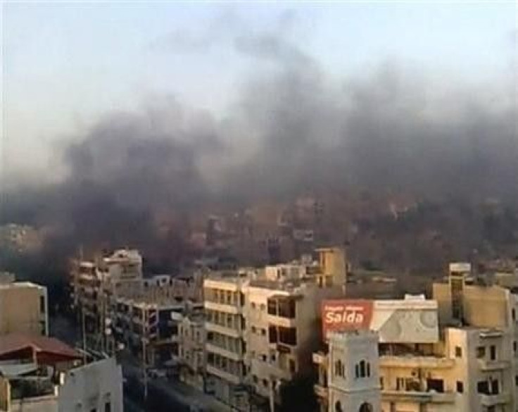 A view shows the smoke rising in the city of Hama in this still image taken from video