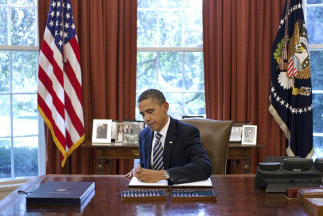 U.S. President Barack Obama signs the Budget Control Act of 2011 in the Oval Office at the White House in Washington