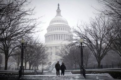A couple walks on the grounds of the U.S. Capitol Building during a snow storm in Washington