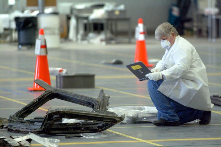 A technician looks at his lap top computer