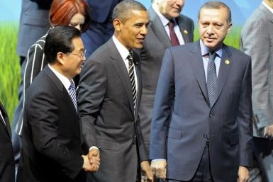 U.S. President Barack Obama (C) shakes hands with China's President Hu Jintao as they walk next to other world leaders during the family photo session at the G20 Summit in Seoul November 12, 2010. 