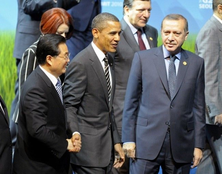 U.S. President Barack Obama (C) shakes hands with China's President Hu Jintao as they walk next to other world leaders during the family photo session at the G20 Summit in Seoul November 12, 2010. 