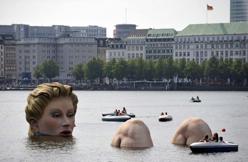 Boats gather around a sculpture of a mermaid at the 039Alster039 lake in Hamburg