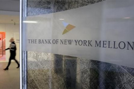 A woman walks past a logo at the office of the Bank of New York Mellon in Brussels