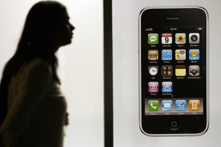 Woman  walks past Swisscom store before joining queue to buy Apple's iPhone 3G after it went on sale in Zurich