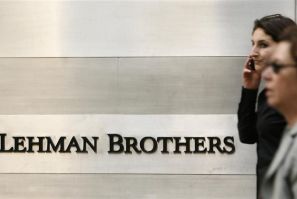 Pedestrians walk past a Lehman Brothers sign in New York