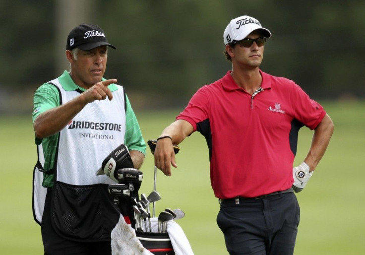 Australia&#039;s Adam Scott listens to his caddie, Steve Williams, on the 13th fairway during the first round of the WGC Bridgestone Invitational PGA golf tournament at Firestone Country Club in Akron