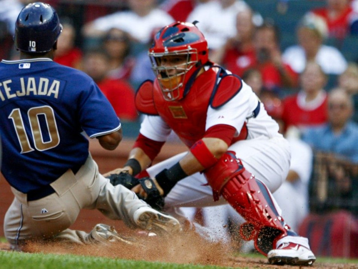 Padres batter Tejada is tagged out at the plate by Cardinals catcher Molina during their MLB National League baseball game in St. Louis