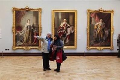 Women browse artworks in the Ramsay Room, during a special viewing of the Scottish National Portrait Gallery in Edinburgh, Scotland November 28, 2011.