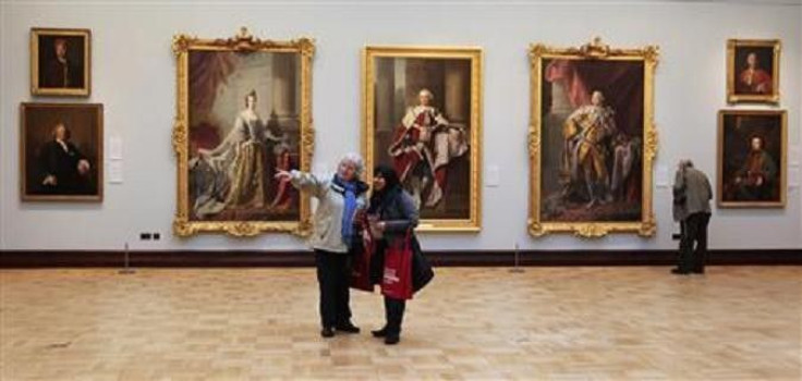 Women browse artworks in the Ramsay Room, during a special viewing of the Scottish National Portrait Gallery in Edinburgh, Scotland November 28, 2011.