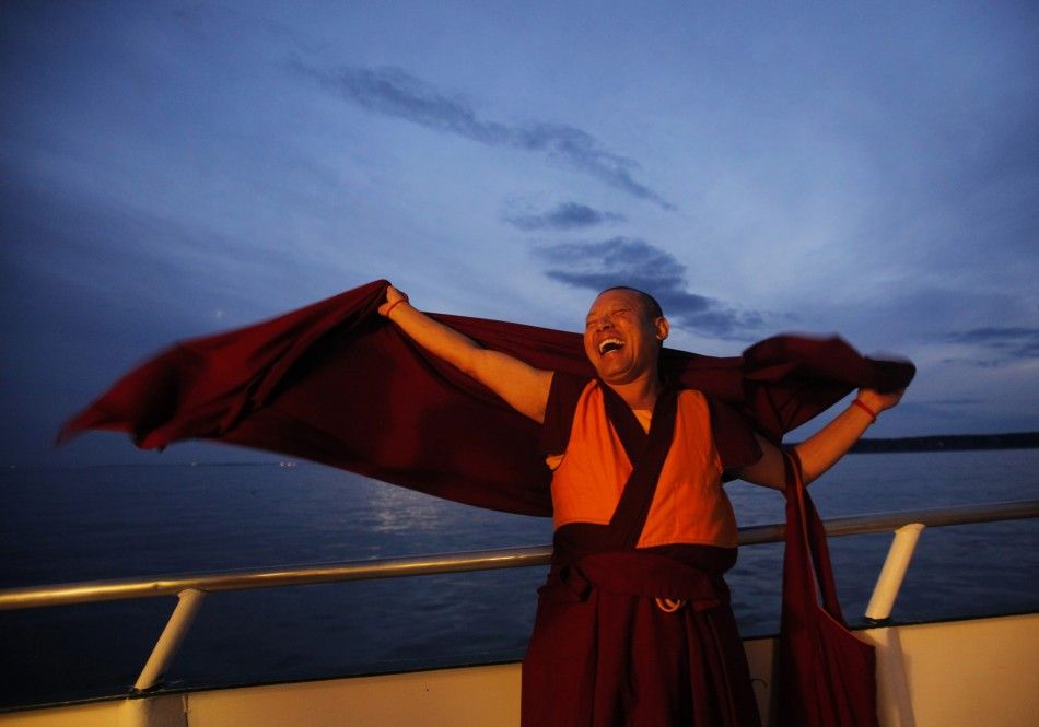 A Buddhist monk laughs during the release of lobsters back into the ocean on quotChokhor Duchenquot in the waters off Gloucester