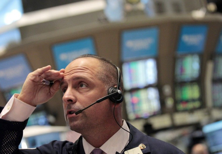 A trader looks on as he works on the floor of the New York Stock Exchange