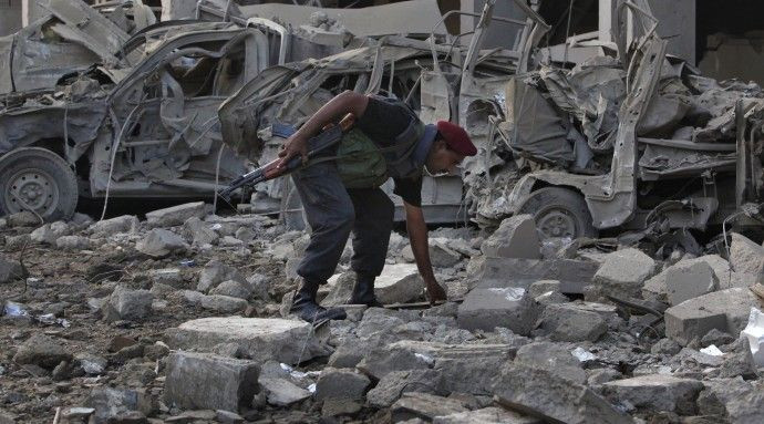A paramilitary soldier goes through the rubbles of the CID building after it was destroyed in a suicide bomb attack in Karachi
