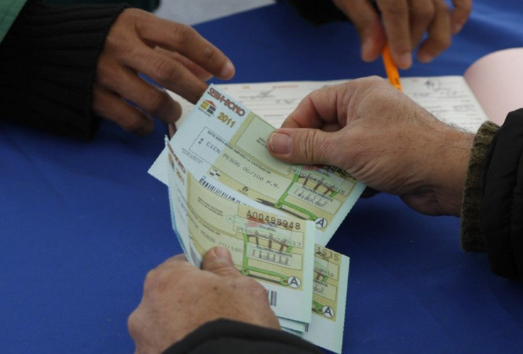 Resident receives food stamps after handed in a pistol during the &quot;Guns Exchange Program&quot; in Monterrey