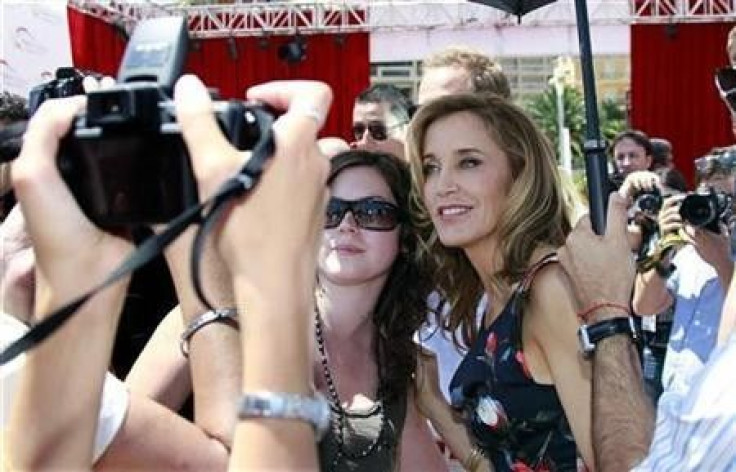 Actress Felicity Huffman (R) who stars in the television series &#039;Desperate Housewives&#039; poses with fans at the 51st Monte Carlo television festival in Monaco