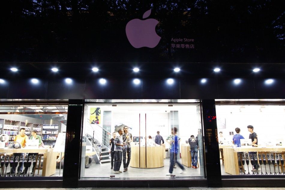 Customers and employees are seen from the exterior of a fake Apple Store in Kunming, Yunnan province July 22, 2011