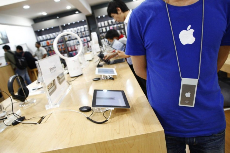 An employee stands inside a fake Apple Store in Kunming, Yunnan province July 22, 2011.