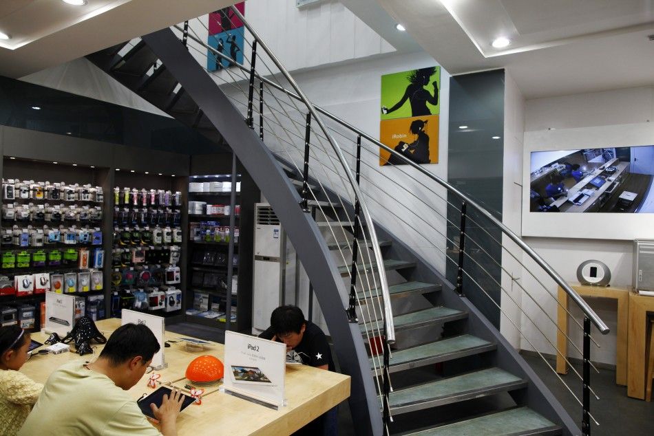 Customers test out electronic products in a fake Apple Store in Kunming, Yunnan province July 22, 2011.