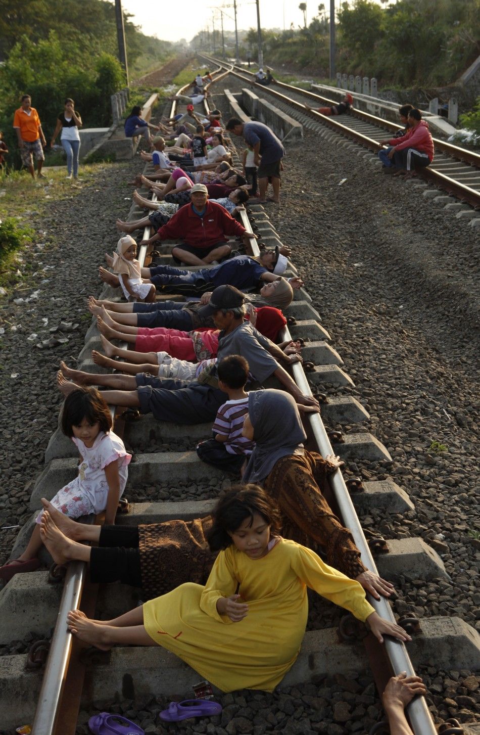 Residents lie on railway tracks in Rawa Buaya in Indonesia039s West Java province.