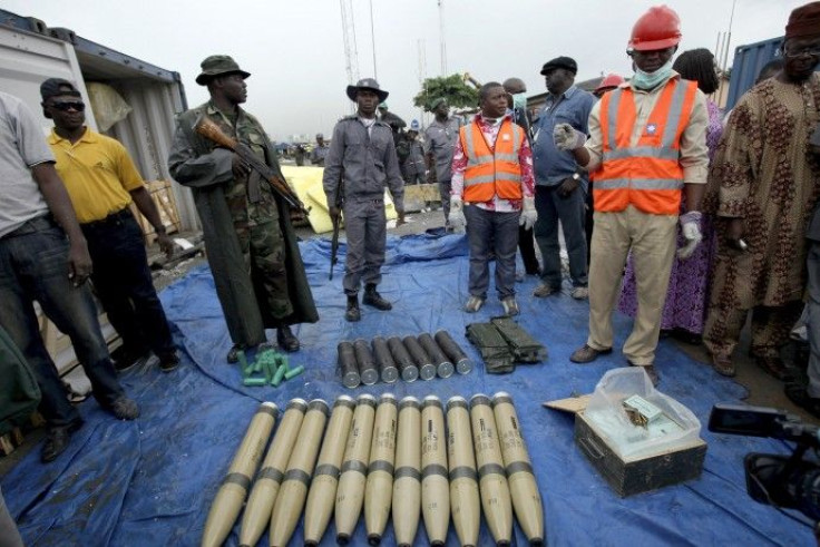 Security officials stand around illegal ammunition at Nigeria's main seaport in Lagos