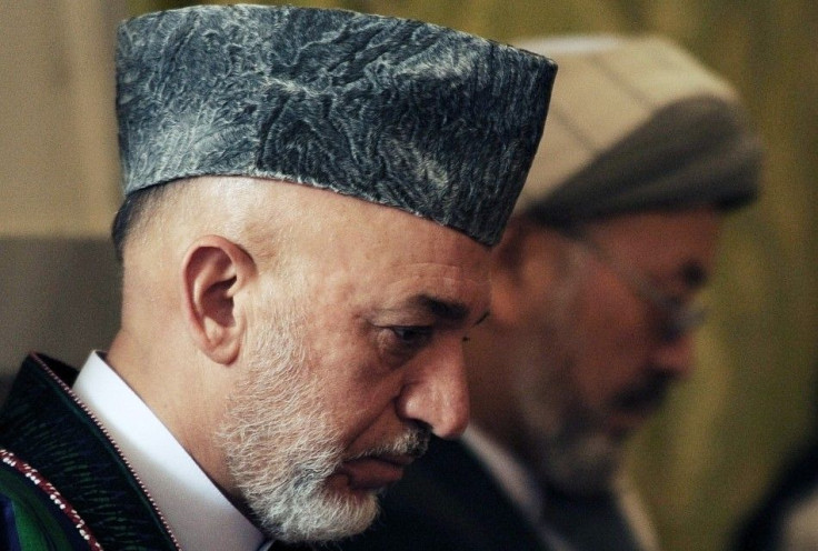 Afghanistan's President Karzai attends the funeral ceremony for his brother Karzai at presidential palace in Kabul