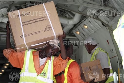 Airport workers offload medical supplies from Kuwaiti airplane as part of humanitarian support for the internally displaced people in Somalias capital Mogadishu