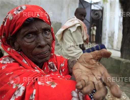 An internally displaced Somali woman begs for assistance outside her shelter in Mogadishu