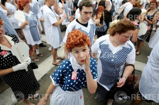 Girl takes part in an attempt to set a new Guinness world record for most Lucy Ricardo lookalikes assembled in one place, in Jamestown