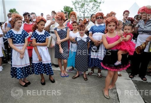 People pose during attempt to set a new Guinness world record for most Lucy Ricardo lookalikes assembled in one place, in Jamestown