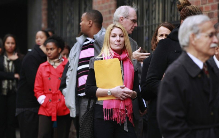 People wait in line to enter a job fair in New York