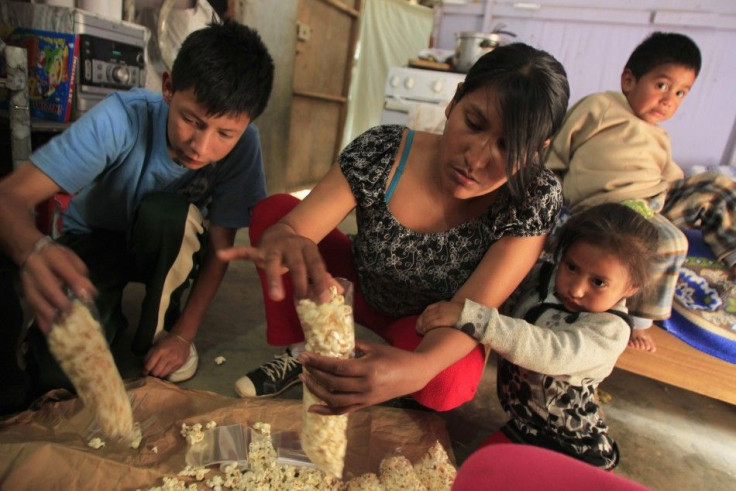 Selmi Marichi packs popcorn to sell in the shantytown of Pamplona Alta in Lima November 22, 2011. Pamplona Alta, home to thousands of families mostly from the highlands, is one of the poorest places in Lima.