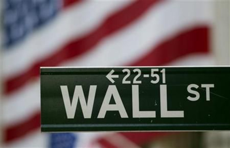 A Wall Street sign hangs on a signpost in front of the New York Stock Exchange