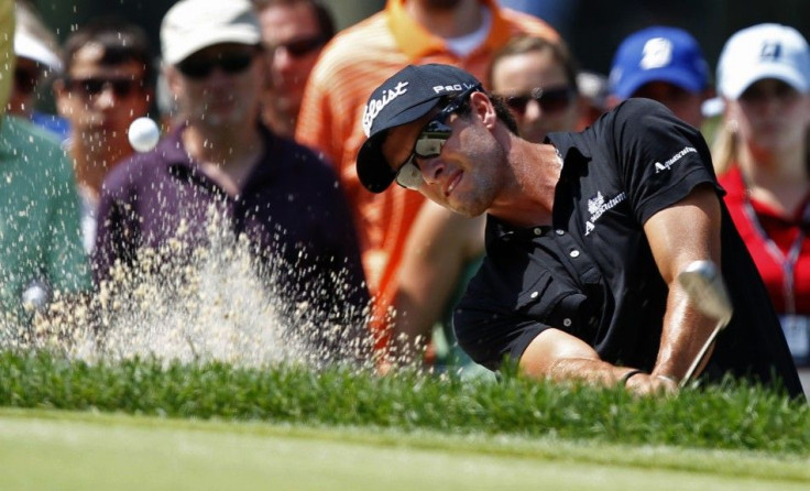 Australia&#039;s Adam Scott hits from a sand trap on the second hole during the final round of the WGC Bridgestone Invitational PGA golf tournament in Akron