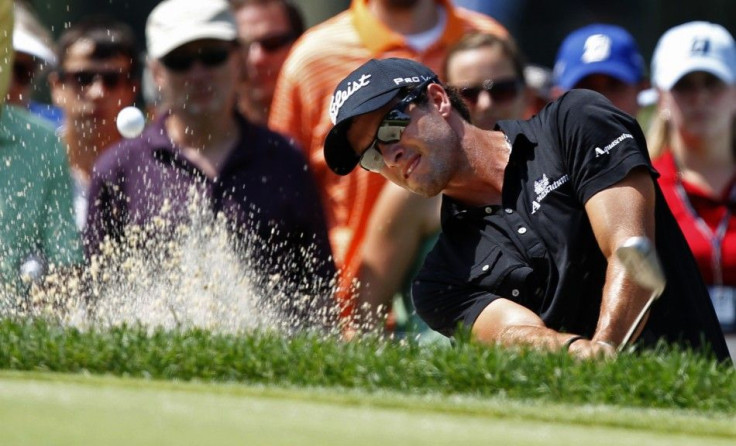 Australia's Adam Scott hits from a sand trap on the second hole during the final round of the WGC Bridgestone Invitational PGA golf tournament in Akron